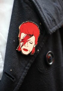 A fan wears a badge of Bowie.